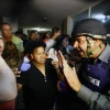 An Israeli border policeman tries to comfort residents in an apartment building after a Grad missile fired by Palestinian terrorists inside the Gaza strip exploded outside their building in Ashdod, Israel, on Oct. 29, 2011. Credit: EPA/EDI ISRAEL.