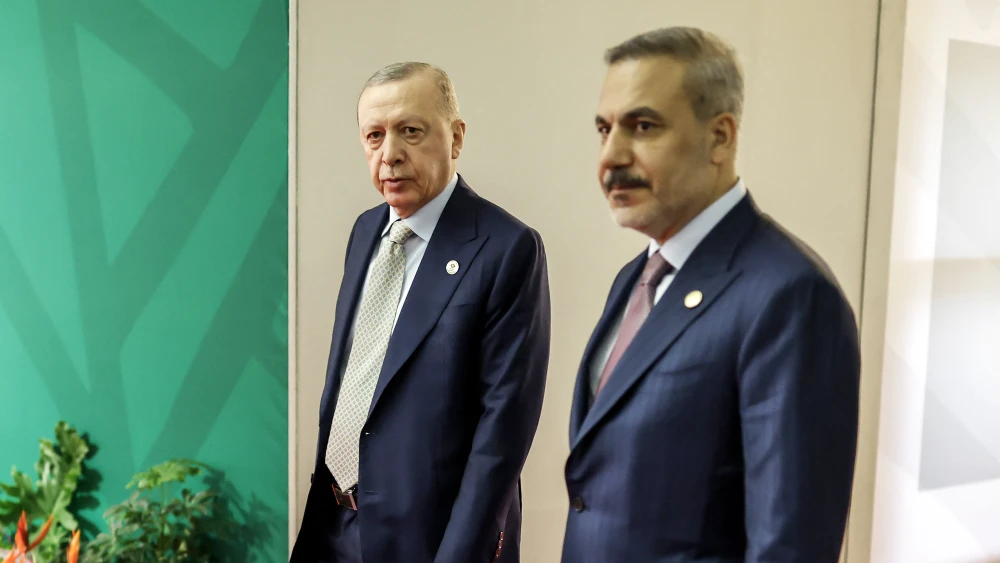 Turkey's President Recep Tayyip Erdoğan (left) and Foreign Minister Hakan Fidan arrive for the second day of the G20 Leaders' Summit at the Nasrec Expo Centre in Johannesburg on Nov. 23, 2025. Photo by Marco Longari/POOL/AFP via Getty Images.