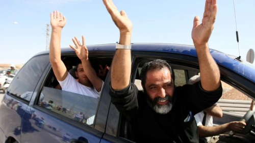 Palestinian terrorists released from Israeli jails, as part of the swap between Israel and Hamas for captive Gilad Shalit, wave as they leave a military base outside Jerusalem, Oct 18, 2011. Photo by Kobi Gideon/Flash90.