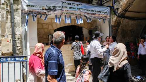 Muslims walk near a shop belongs to Israelis during Ramadan in the Muslim Quarter of Jerusalem's Old City on May 20, 2018. Photo by Sliman Khader/Flash90.