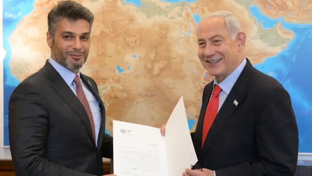 Israeli Prime Minister Benjamin Netanyahu, right, receives a formal invitation to attend COP28 in Dubai from UAE Ambassador to Israel Mohamed Mahmoud Al Khaja on May 22, 2023 in Jerusalem. Photo by Amos Ben-Gershom (GPO)