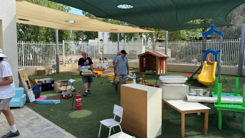 Volunteers set up a kindergarten playground at Kibbutz Nir Am, Aug. 20, 2024. Photo by Debbie Dash.