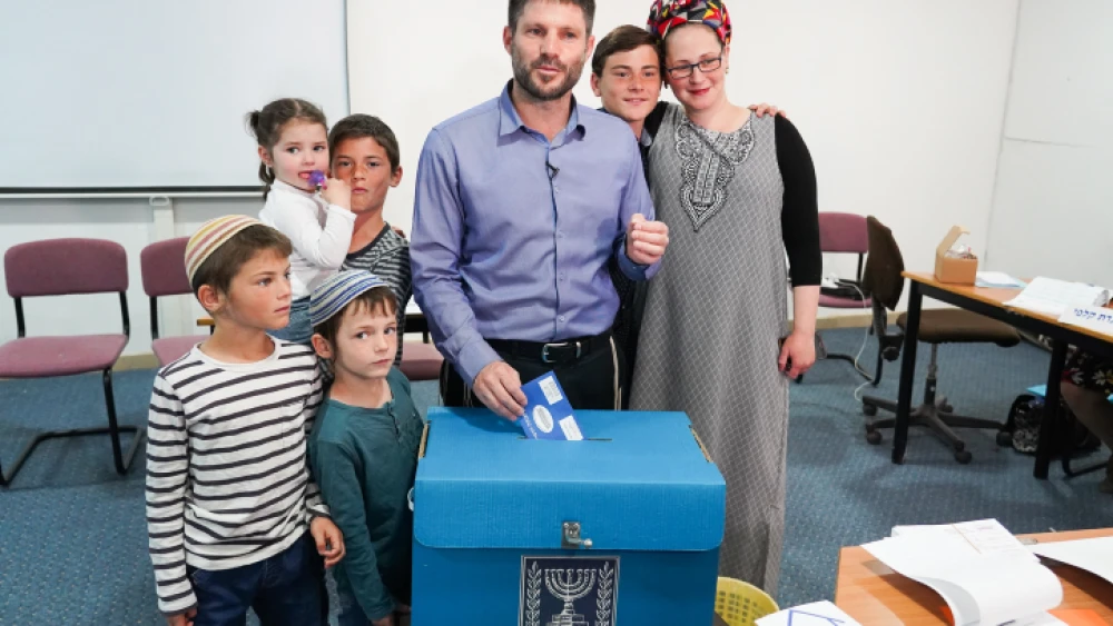 Head of the National Union Party Bezalel Smotrich casts his ballot, with his family in tow, at a voting station in the Judea town of Kedumim on April 9, 2019. Photo by Hillel Maeir/Flash90.