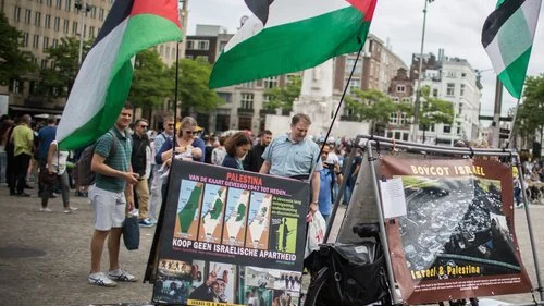A pro-BDS display, with photos and PLO flags, at Dam Square in central Amsterdam, June 24, 2016. Photo by Hadas Parush/Flash90.