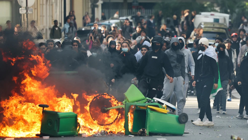 A student puts trashes into a fire as protesting students carry out blockading action near place de la Nation, in Paris, on Oct. 2, 2026. Photo by Thomas Samson/AFP via Getty Images.