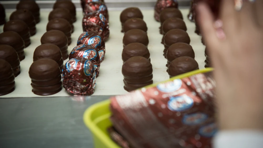 The production line of the "Menbo," where workers cover each "Krembo" with tinfoil by hand at the factory in Rehovot, Oct. 27, 2015. Photo by Hadas Parush/Flash90.