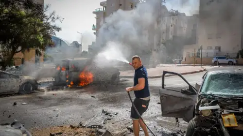 A man works to extinguish a fire ignited by a Gazan rocket strike in Ashkelon, Oct. 7, 2023. Photo by Jamal Awad/Flash90.