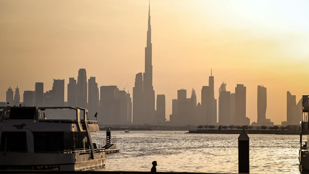 A man walks along Dubai's Creek Harbour, with the Burj Khalifa visible in the background, on April 3, 2026. Photo by Fadel Senna/AFP via Getty Images.