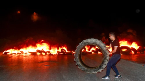 A Palestinian demonstrator burns tires near Joseph's Tomb in the West Bank city of Nablus on July 2, 2019, as thousands of Jews make their way to visit the grave. Photo by Nasser Ishtayeh/Flash90.