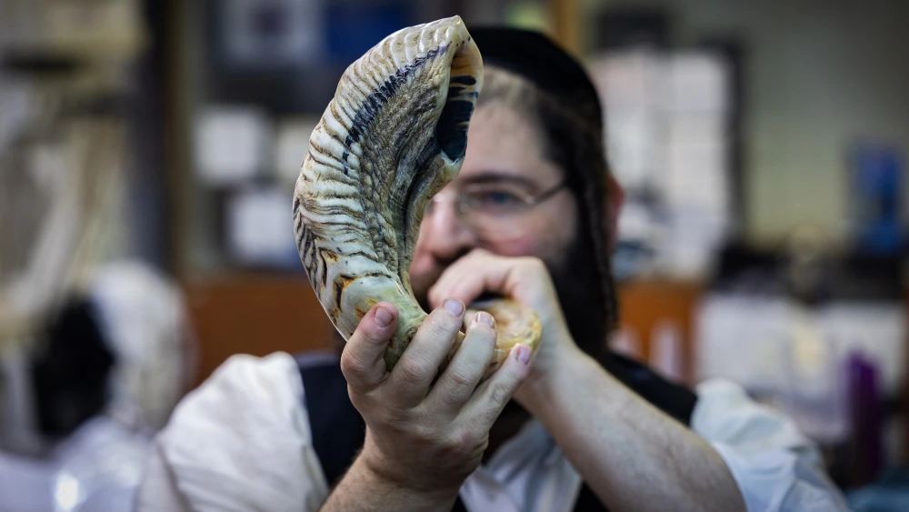 An Orthodox Jewish man tests out a shofar at a store in the Mea She'arim neighborhood of Jerusalem ahead of the Jewish holiday of Rosh Hashanah, on Sept. 15, 2025. Photo by Chaim Goldberg/Flash90.