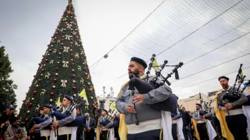 Palestinians march during a Christmas parade outside the Church of the Nativity on the eve of Christmas, Dec. 24, 2022. Photo by Wisam Hashlamoun/Flash90.
