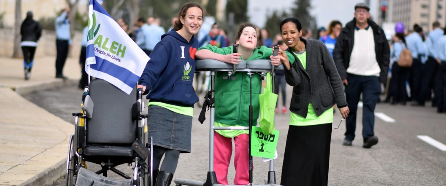 Volunteers and their young charge at a march for ALEH, Israel’s network of care for children with severe complex disabilities. Credit: Courtesy.