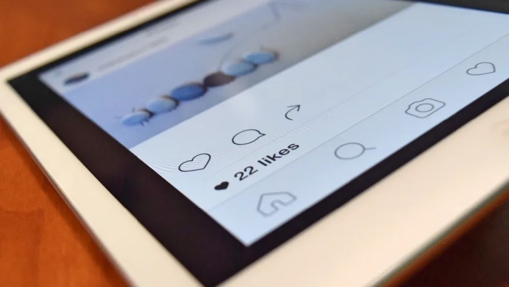 Close-up of a tablet showing a social media post. Credit: Pixabay.