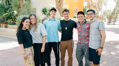 College students involved in JLIC pose for a picture on a college campus. Credit: Courtesy.