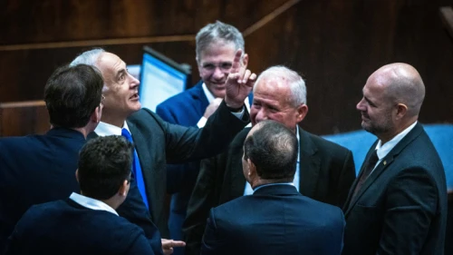 Likud leader Benjamin Netanyahu speaks with Likud MKs during a Knesset vote, Dec. 28, 2022. Photo by Olivier Fitoussi/Flash90.