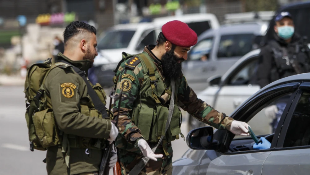 Palestinian security personnel block the entrance to the Samarian city of Nablus (Shechem), March 23, 2020. Photo by Nasser Ishtayeh/Flash90.