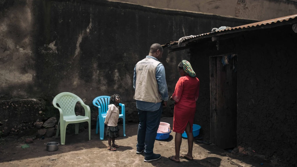 A Bridgeway Foundation team member talks to a woman in Kasindi, Beni Territory, North Kivu Province in the eastern Democratic Republic of Congo, who was kidnapped by the ADF (Allied Democratic Forces) but managed to escape and went to a deradicalization center, May 9, 2024. Photo by Alexis Huguet/AFP via Getty Images.