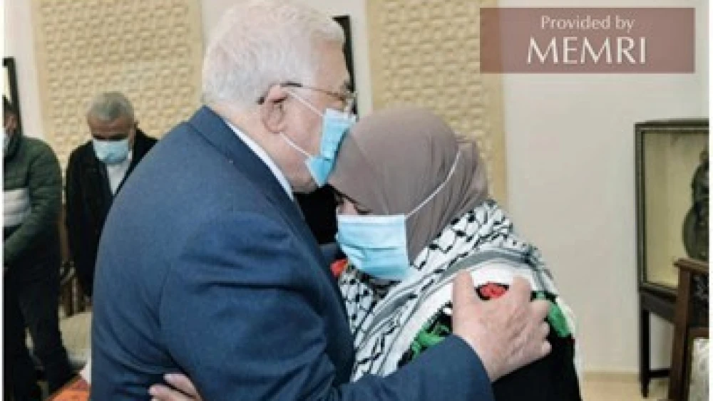 Palestinian Authority leader Mahmoud Abbas embraces Latifa Abu Hmeid, the mother of six terrorists as confirmed by Israel, during a meeting in Ramallah on Jan. 12, 2022. Source: Al-Hayat Al-Jadida, Jan. 13, 2022. Credit: MEMRI.