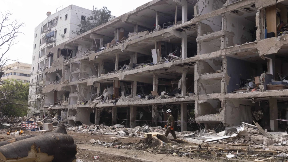 An IDF Home Command soldier walks through rubble a day after an Iranian ballistic-missile hit in Tel Aviv, June 23, 2025. Photo by Amir Levy/Getty Images.