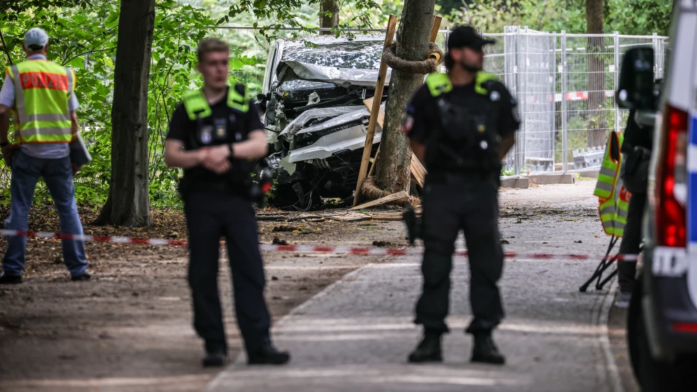 German police stand near a white van that suspect Abdul B. used in an attack against revelers at the Christopher Street Day Berlin Pride Parade in Germany, July 26, 2026. Photo by Omer Messinger/Getty Images.