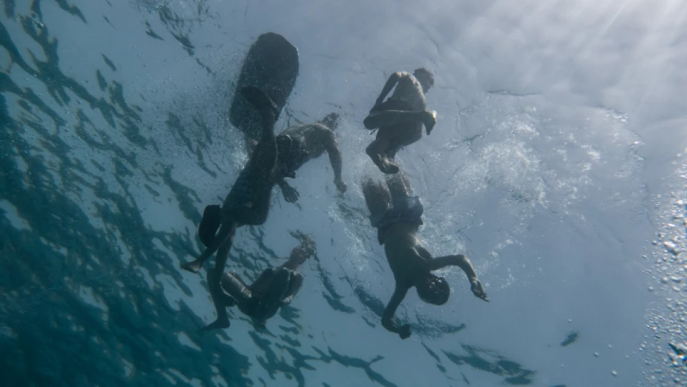 People swim in the Gulf of Eilat in the Red Sea, May 19, 2018. Photo by Maor Kinsburksy/Flash90.