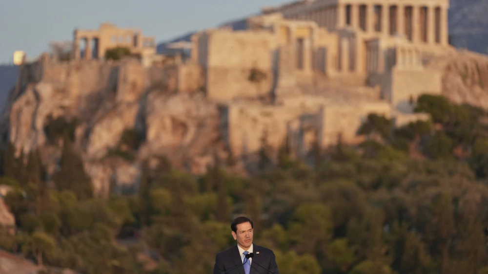 U.S. Secretary of State Marco Rubio speaks at the Pnyx hill, where ancient Athenians held democratic assemblies, with the ancient Parthenon temple atop the Acropolis seen in the background, in Athens on Oct. 7, 2026. Photo by Mark Schiefelbein/POOL/AFP via Getty Images.