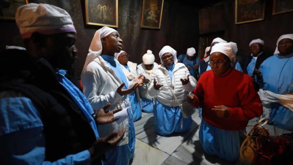 Christian pilgrims pray inside the Church of the Nativity in the West Bank city of Bethlehem, on Dec. 24, 2019. Photo by Flash90.