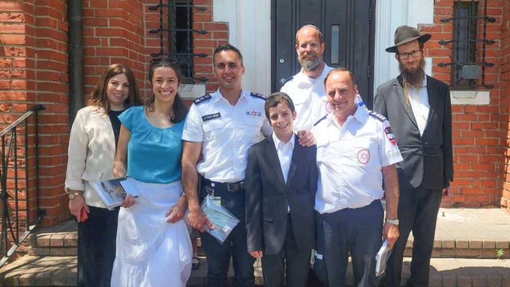13-year Shmuel Kovetzik (front, center) celebrating his bar mitzvah on July 19, 2023 with his family and the emergency medics who saved his life. Photo by Magen David Adom.