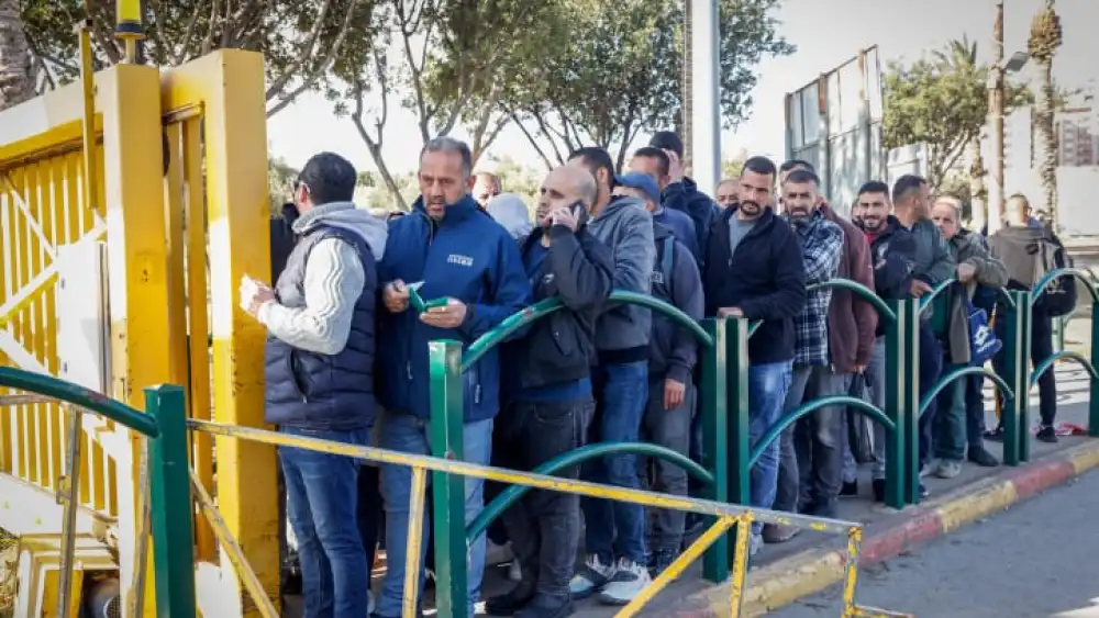 Palestinian workers line up at the entrance to Ma'ale Adumim near Jerusalem, Feb. 23, 2023. Photo by Erik Marmor/Flash90.