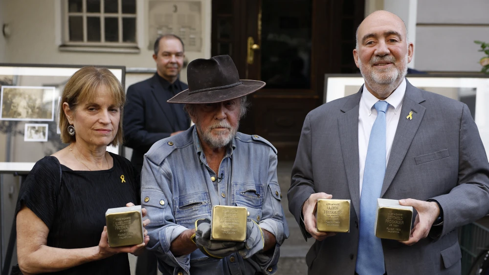 Israeli ambassador to Germany Ron Prosor (R), his wife Hadas (L) and Gunter Demnig, founder of the Stolpersteine project, hold cubes commemorating Prosor's relatives in Berlin on Sept. 23, 2024. Photo by Odd Andersen/AFP via Getty Images.