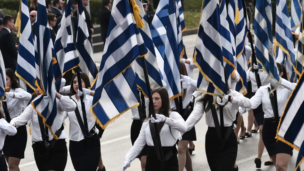 Students holding Greek flags take part in a military parade in Thessaloniki on Oct. 28, 2018, during the celebrations marking Greece's National "Oxi" (No) Day, commemorating Greece's refusal to accept the ultimatum advanced by fascist Italy in 1940 during World War II. Photo by Sakis Mitrolidis/AFP via Getty Images.