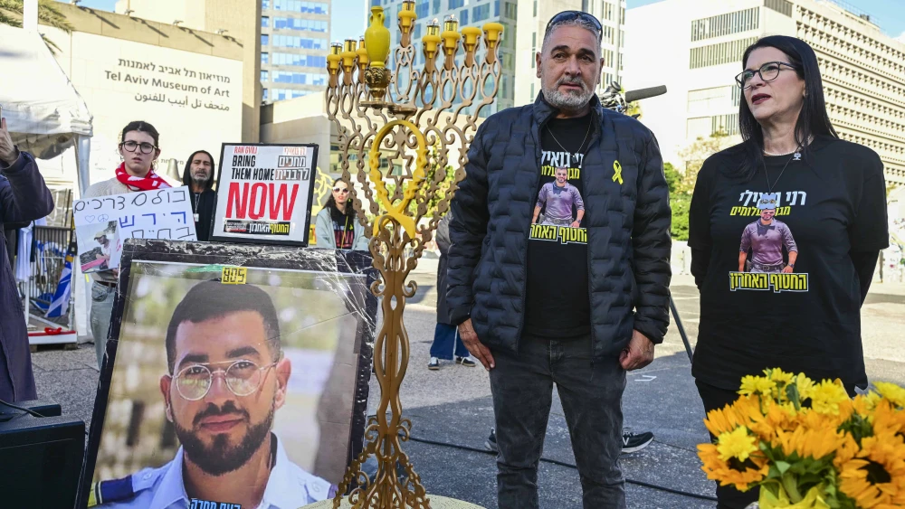 Relatives, friends and supporters of Master Sgt. Ran Gvili, whose body is held by Hamas, attend a Kabbalat Shabbat ceremony and the lighting of Hanukkah candles at Hostage Square in Tel Aviv, calling for the return of his body from Hamas captivity, on Dec. 19, 2025. Photo by Avshalom Sassoni/Flash90.