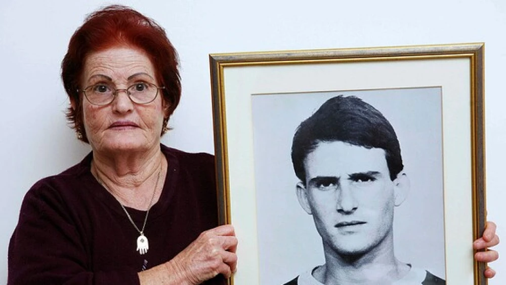 Galia Tamam holds a picture of her son, Moshe, who was murdered by Palestinian terrorists in 1984. Photo by Yehoshua Yosef.