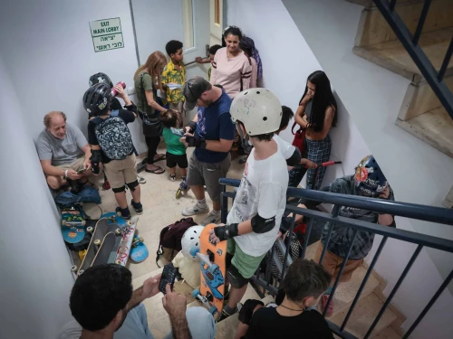 Israelis take cover inside a bomb shelter as an air-raid siren sounds in Tel Aviv, Oct. 26, 2023. Photo by Noam Revkin Fenton/Flash90.