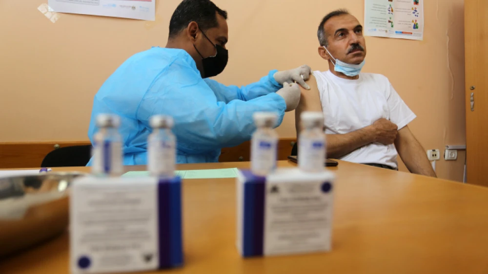 A medical worker administers a COVID-19 vaccine at the UNRWA clinic in Rafah in the southern Gaza Strip on March 3, 2021. Photo by Abed Rahim Khatib/Flash90.