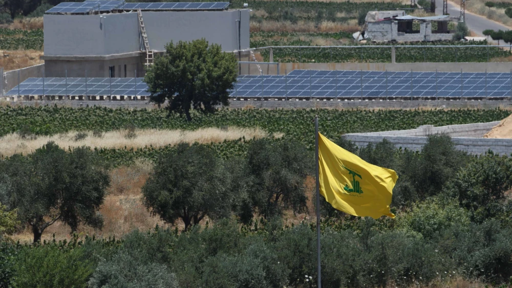A Hezbollah flag in Lebanon, as seen from the Israeli side of the border, June 27, 2023. Photo by Ayal Margolin/Flash90.