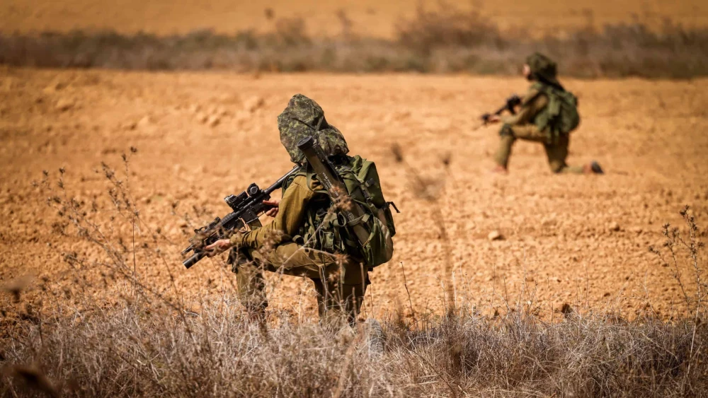 Israeli soldiers take position on a main road near the Israeli-Gaza border, Oct. 10, 2023. Photo by Chaim Goldberg/Flash90.