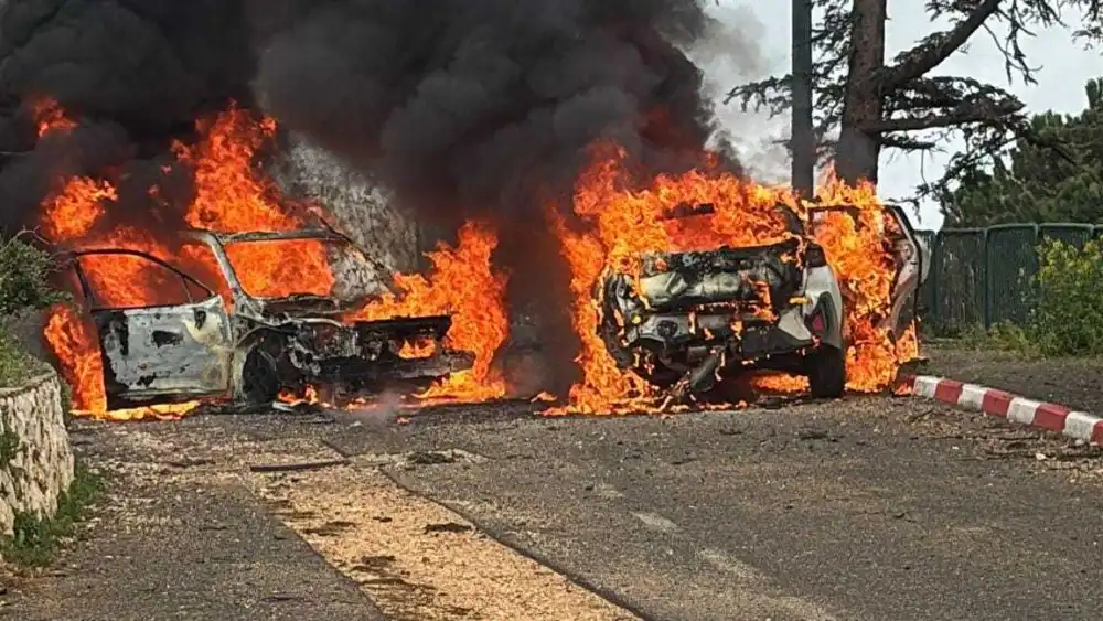 Two vehicles go up in flames following a Hezbollah strike near a community in Israel's Galilee Panhandle, March 22, 2026. Credit: Magen David Adom.