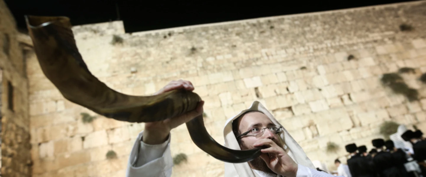 A shofar is blown at the Western Wall in Jerusalem's Old City, at the end of Yom Kippur, Oct. 12, 2016. Photo by Flash90.