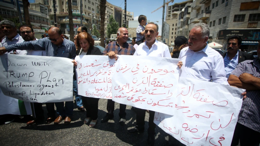 Palestinians demonstrate against the U.S.-led economic workshop being hosted by Bahrain this week, in the West Bank city of Ramallah, June 15, 2019. Photo by Flash90.