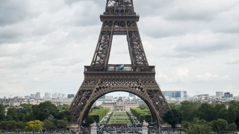 Members of the activist group Extinction Rebellion Paris unfurl a large Palestinian flag from the Eiffel Tower in Paris on May 15, 2026. Photo by Antoine Berlioz/Hans Lucas/AFP via Getty Images.