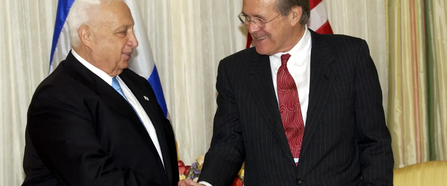Former U.S. Defense Secretary Donald Rumsfeld with Israeli Prime Minister Ariel Sharon in October 2002. Credit: Avi Ohayon/GPO.