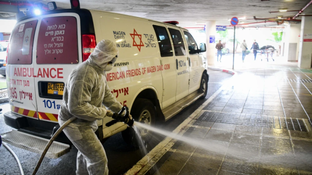 Israeli firefighters wear protective clothes to disinfect Ichilov Hospital in Tel Aviv as part of measures to prevent the spread of the coronavirus, March 20, 2020. Photo by Flash90.