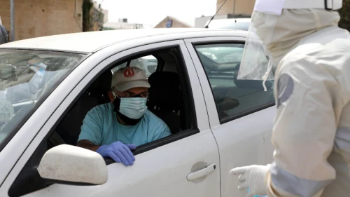 Palestinian security forces stop a driver attempting to enter the West Bank city of Hebron, as part of the Palestinian Authority's steps to prevent the spread of the coronavirus, April 19, 2020. Photo by Wisam Hashlamoun/Flash90.