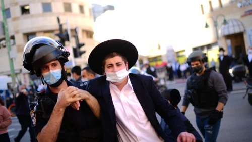 Israeli police clash with haredi Jews during a protest against the police enforcement of lockdown orders due to the coronavirus, in the city of Bnei Brak on Jan. 24, 2021. Photo by Tomer Neuberg/Flash90.