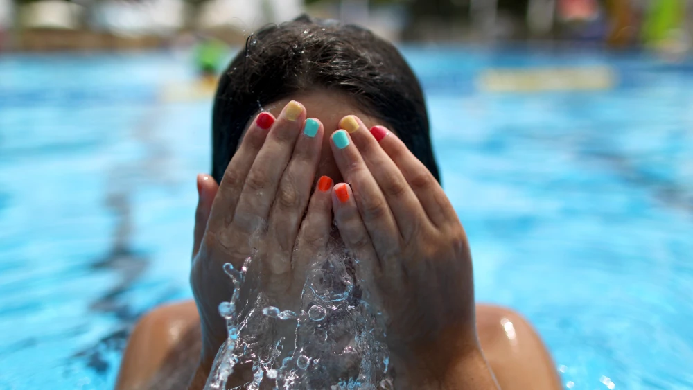 File photo: An Israeli girl swims at Kibbutz Shefayim in central Israel. Photo by Nati Shohat/Flash90.