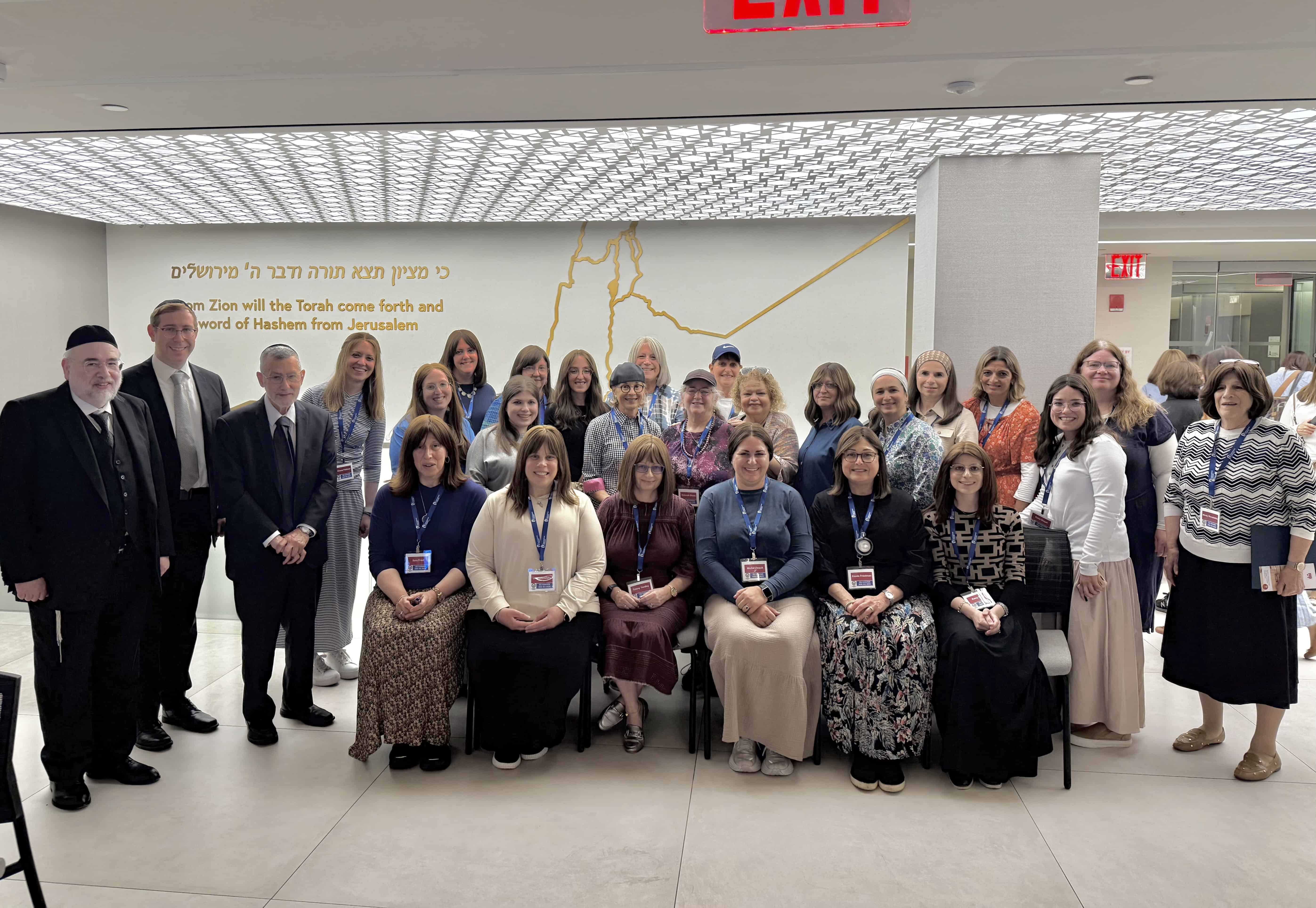 L to R, at the ASK OU 2025 Summer Women's Kashrus Experience: OU Kosher ‘s Chief Operating Officer Rabbi Moshe Elefant; Managing Director of Community Relations Rabbi Eli Eleff; and Chief Executive Officer Rabbi Menachem Genack, with a group of seminar participants.
